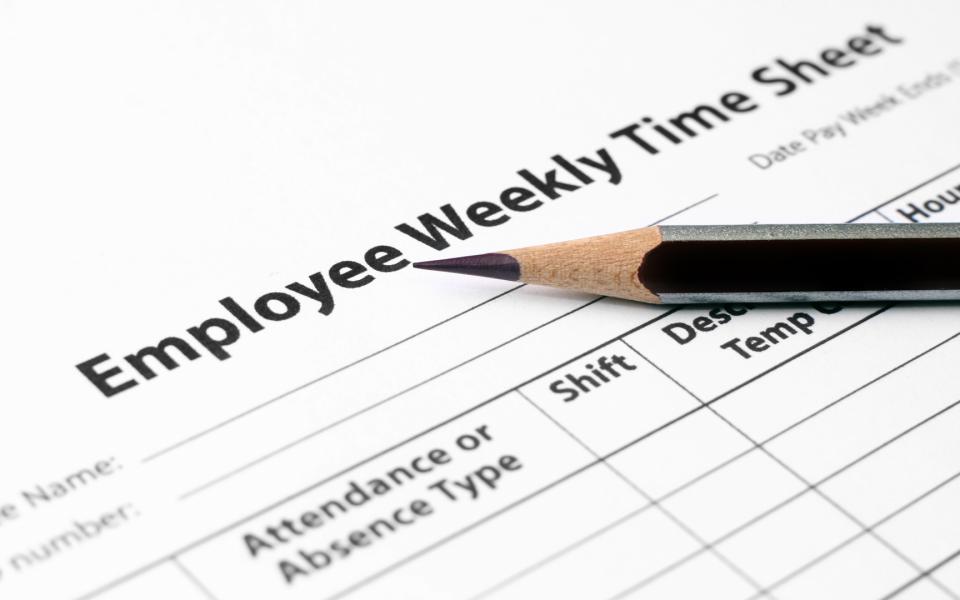 Close up of a pencil laying on top of an Employee Weekly Time Sheet
